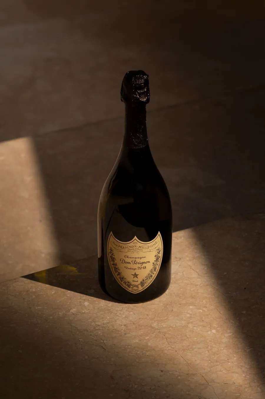 A bottle of Dom Pérignon in a beam of light