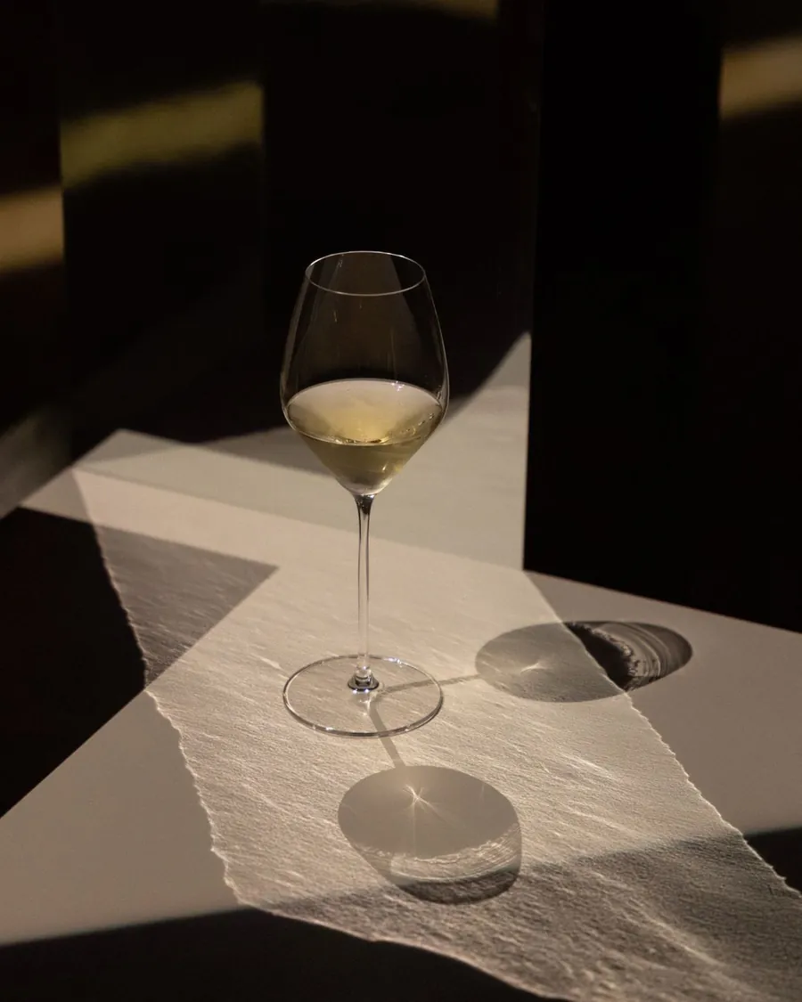 Dom Pérignon Révélations 2026: a glass of champagne on paper in raking light