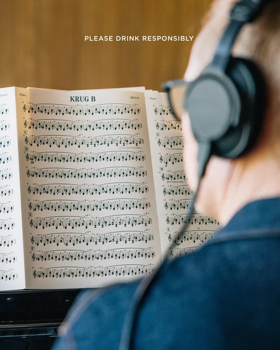 A Krug score on a music stand, headphones in the foreground